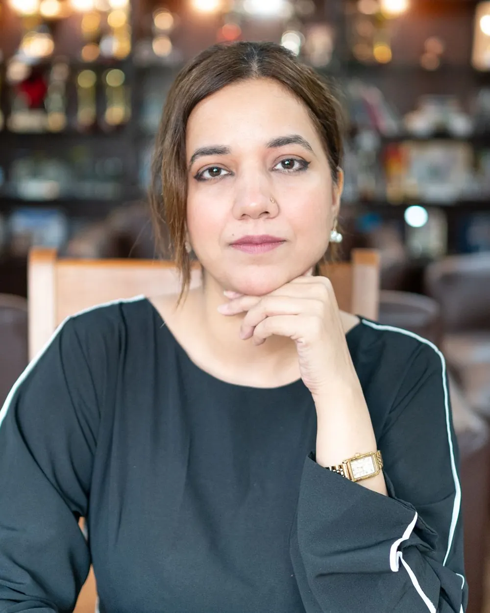 A confident professional woman seated in a modern office