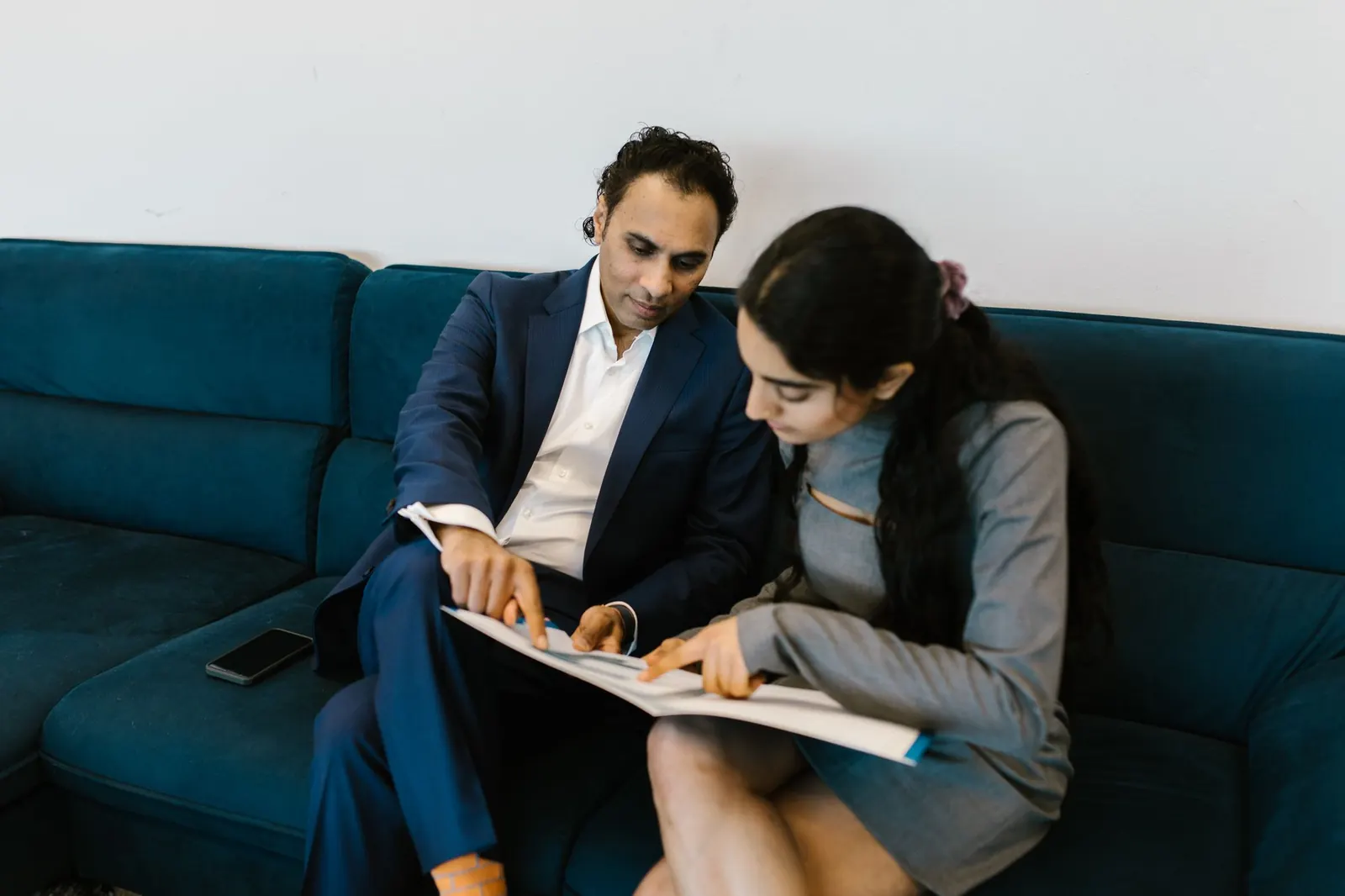 Two colleagues reviewing a document together