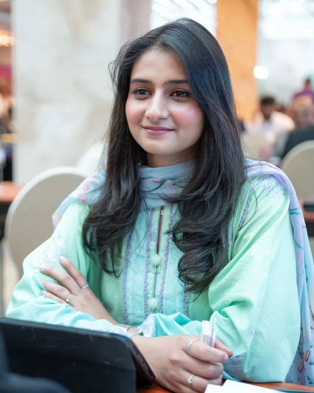 A young professional smiling during a recruitment event
